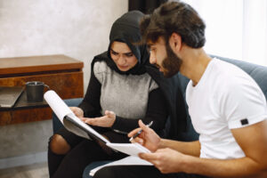 Husband & Wife, sitting on sofa, going over home loan documents